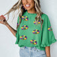 Green Sequin Doughnut Graphic Ruffled Trim Bell Sleeve Mardi Gras Blouse